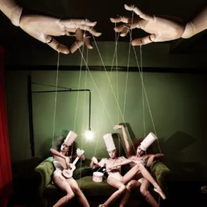 Kristian Schuller Puppets giant hand pulling models on strings