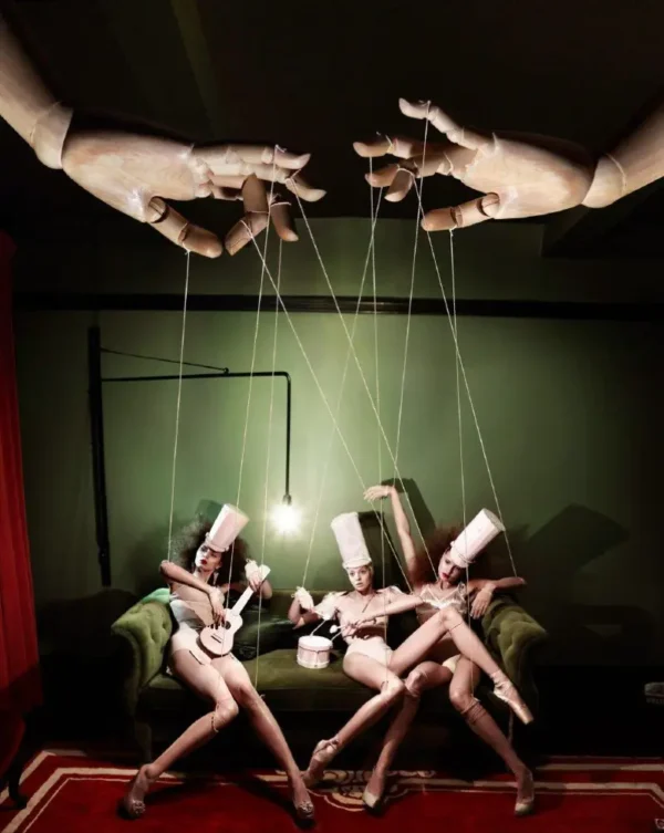 Kristian Schuller Puppets giant hand pulling models on strings