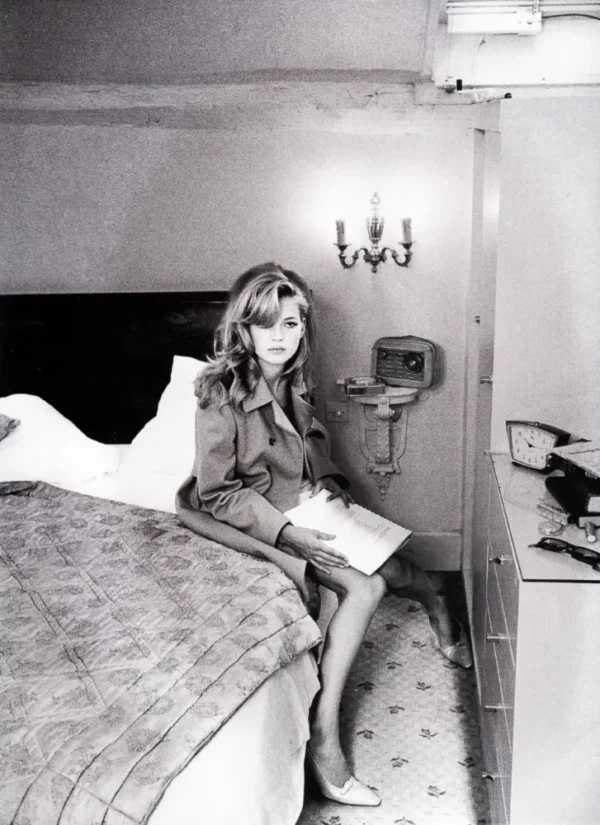 Unwerth Kate Moss Reading US Vogue, supermodel sitting on a bed