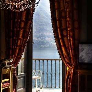 David Drebin, Lake View through balkony door with heavy red kurtains and chandelier, heels on the floor