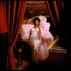 Singer Aretha Franklin Photographed between red velvet curtains in a pink tulle dress, photographed by timothy white